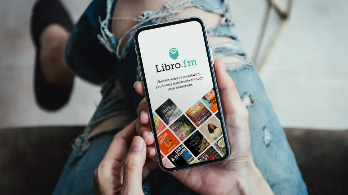 Person holding photo using Libro.fm audiobook app