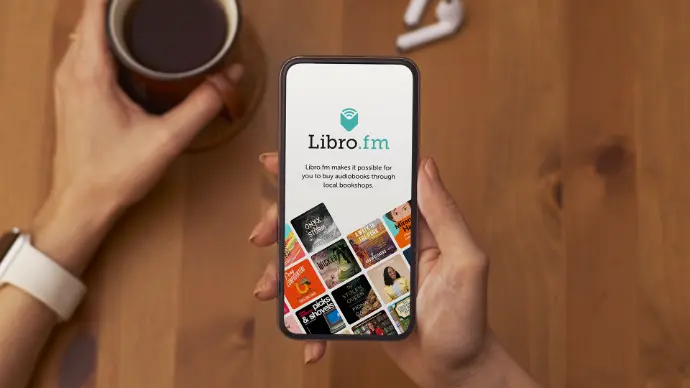 Person holding photo using Libro.fm audiobook app